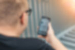 Man using a self-care app on his smartphone as part of his daily mental health and wellness routine
