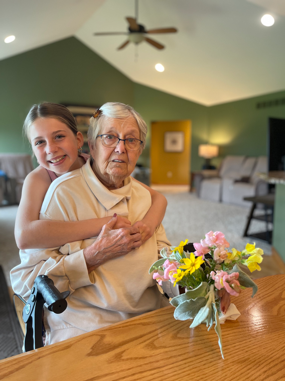 Child sharing a warm embrace with a resident.