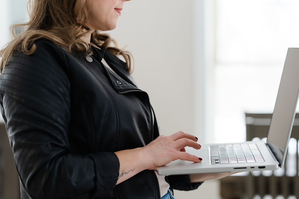 Amye from Liquia Design working on her laptop, designing psychology-driven websites that convert visitors into clients