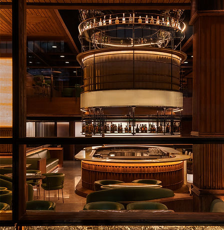 Window-side view of Muro’s stylish bar area with warm lighting and modern seating