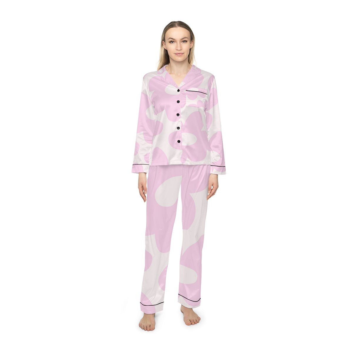 Woman wearing pink pajama set posing on white background fashion