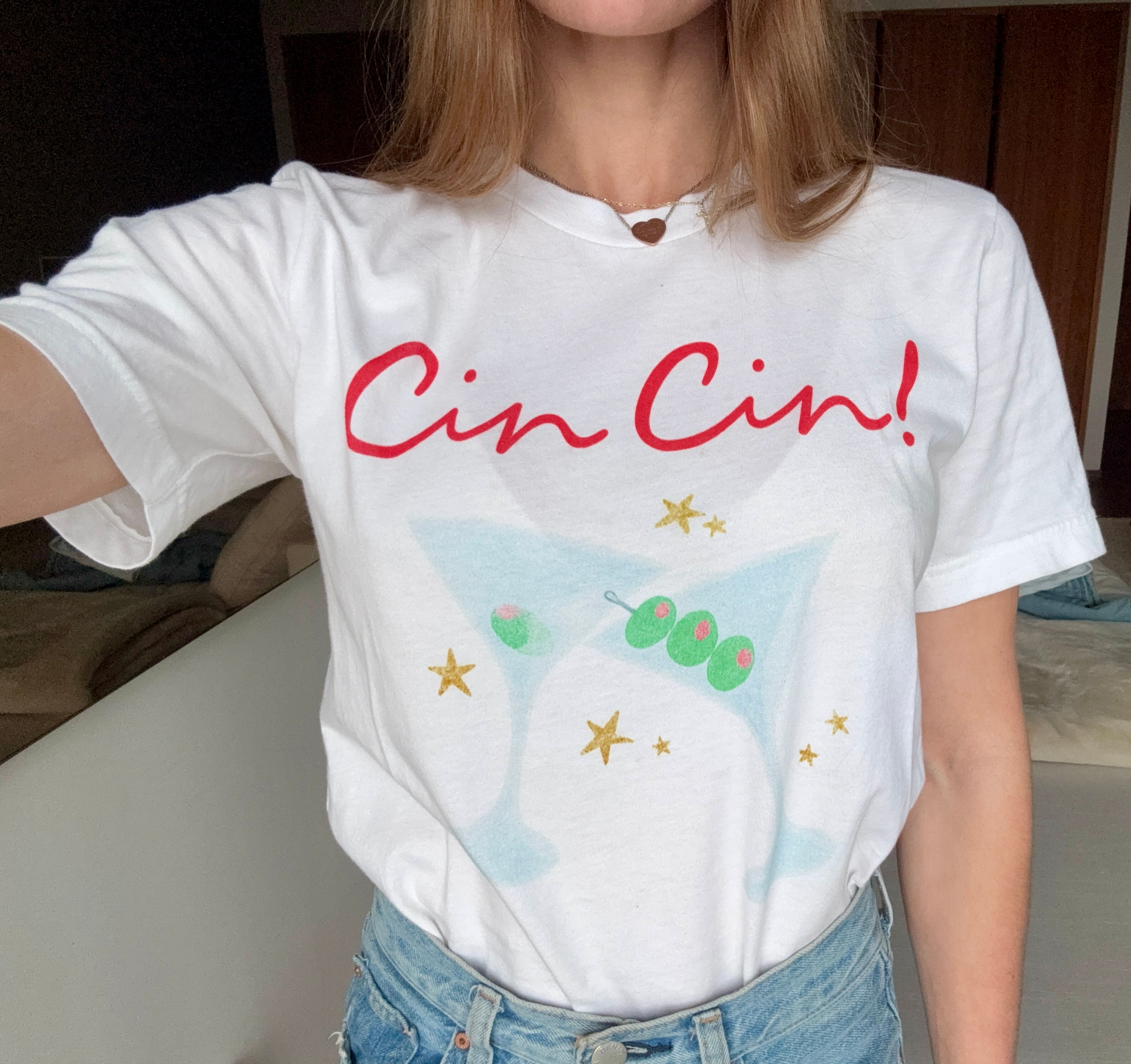Woman wearing Cin Cin! Unisex Jersey Short Sleeve Graphic Tee - Cocktail Party T-Shirt with martini design.