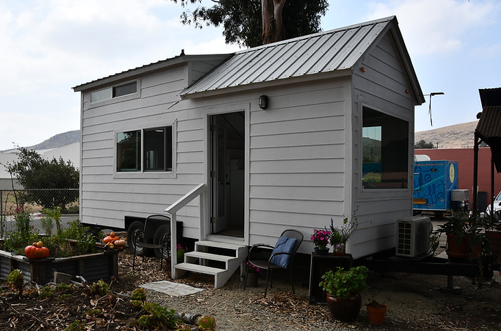 Demo cottage from the side with the front door open