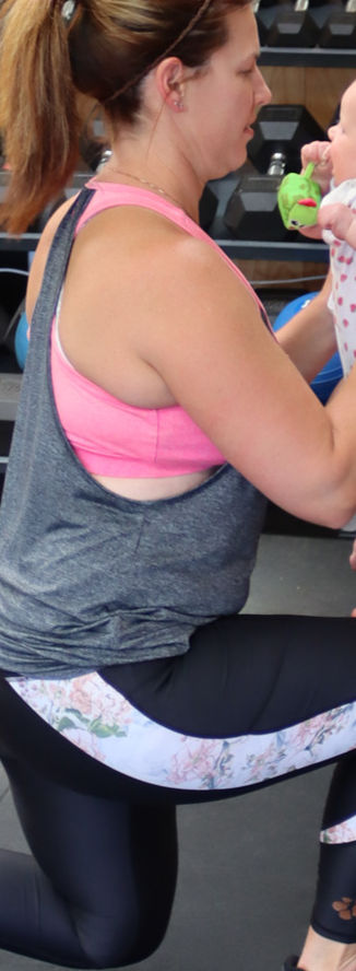 Woman lunging, holding baby: Energised Ladies fitness
