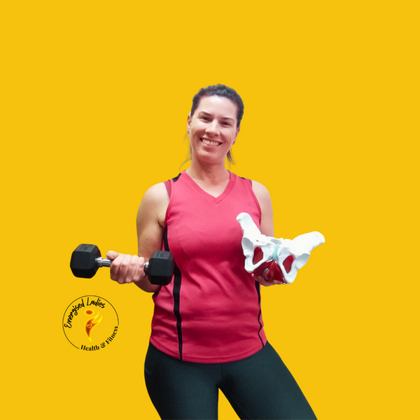 A lady in a pink top holding a pelvis model and dumbbell