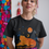 Thumbnail: Black feminist solidarity t-shirt with tigress and panther graphic laid flat with accessories