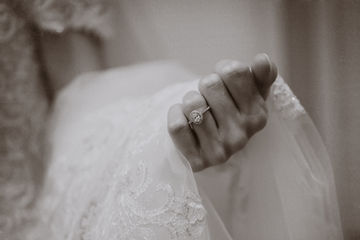 A quick detail shot of the engagement ring as she checks her manicure while holding her veil - Julia Bailey