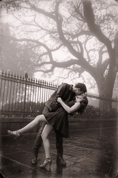 A man dips his fiance and kisses her next to Jackson Square on an overcast day - Julia Bailey