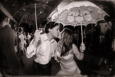 Newlyweds kiss each other during their second line dance at the end of their night - Julia Bailey