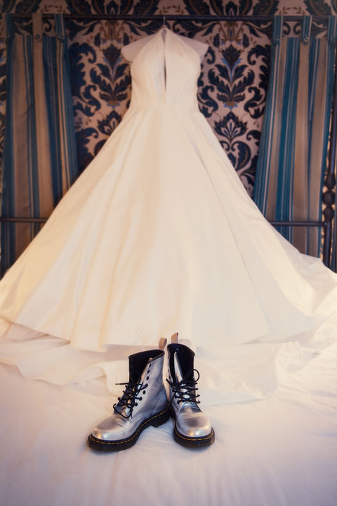 The bride's silver Doc Martin's sit on the train of her dress during the bridal prep - Julia Bailey