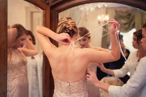 Last minute adjustments to a brides dress during her bridal prep - Julia Bailey