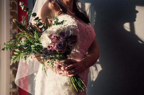 Detailed shot of a bridal bouquet held by a bride as she poses for a different photographer - Julia Bailey