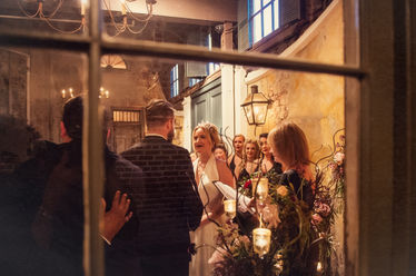 A photographer uses a window to get a different vantage off the wedding of Bryan and Jessica at Latrobe's on Royal - Julia Bailey
