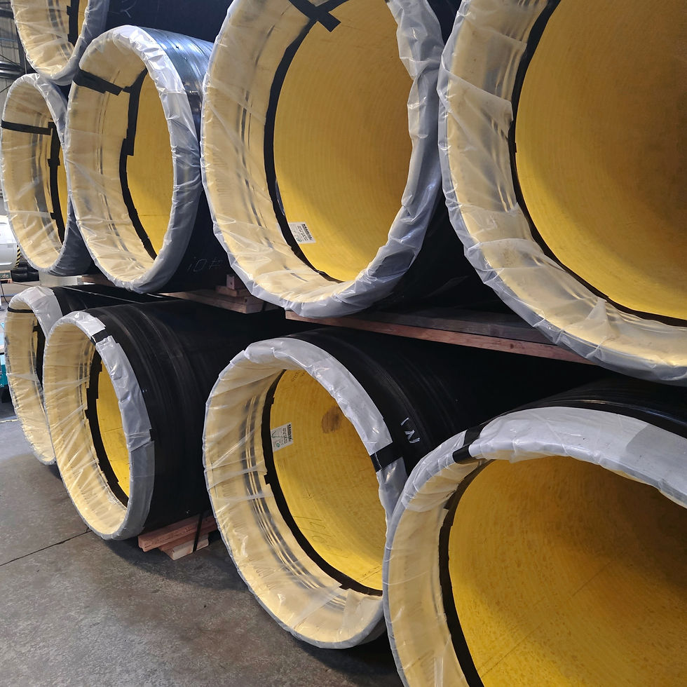 Several large metal pipes interconnected, showcasing a robust industrial setup in a factory environment.
