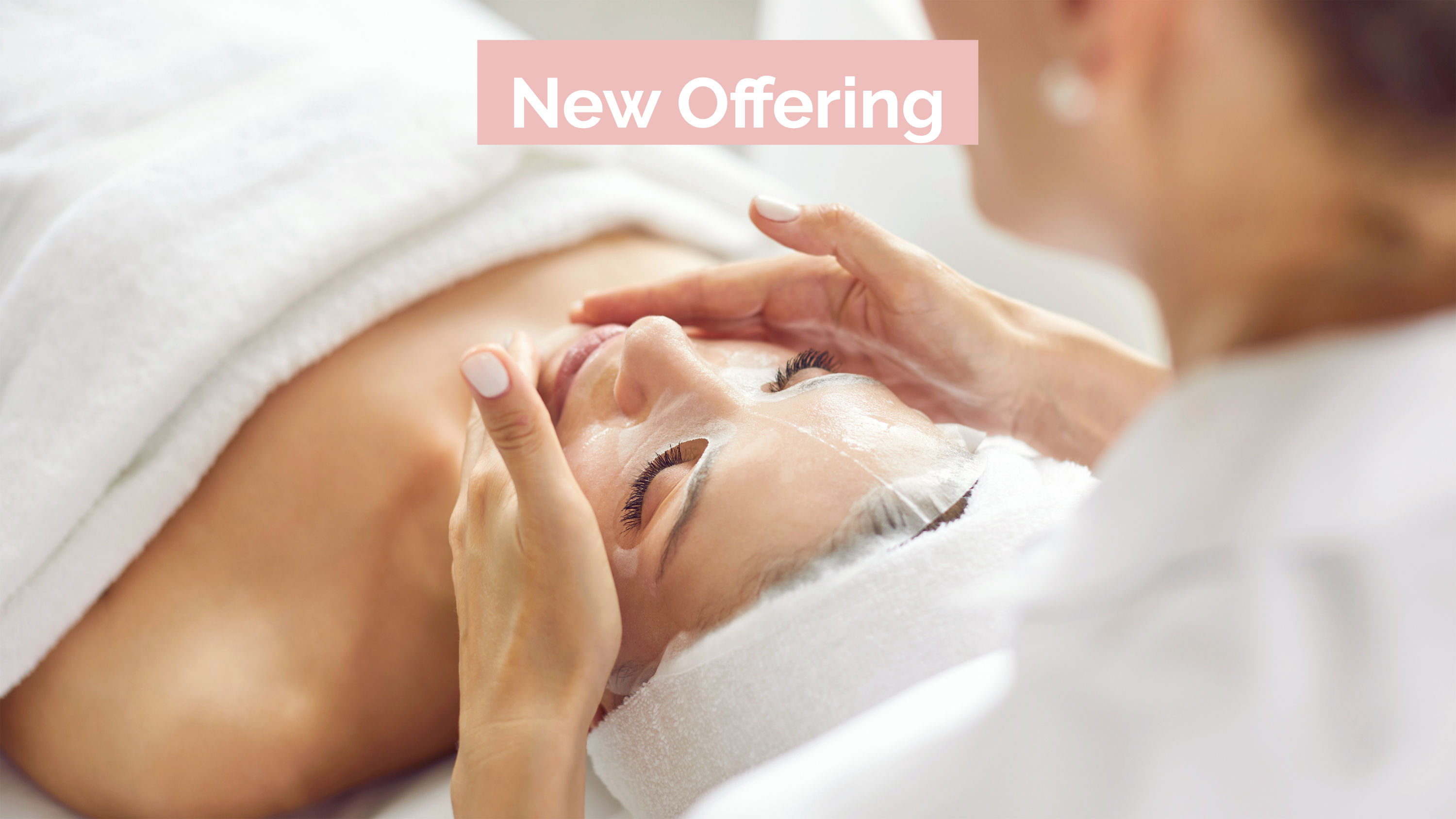 A woman receiving a Divine Facial in Reynella. She has a towel wrapped around her scalp to protect her hair.
