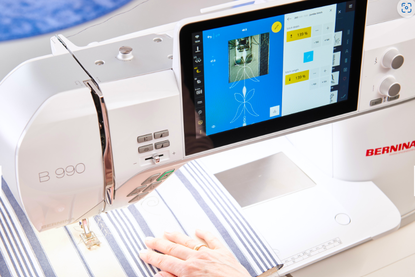 Thumbnail: Touch screen with standard stitches showing, with laser pointer engaged on fabric on Bernina 990