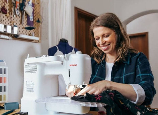 Thumbnail: lady sewing on b325 bernina sewing machine in a sewing room