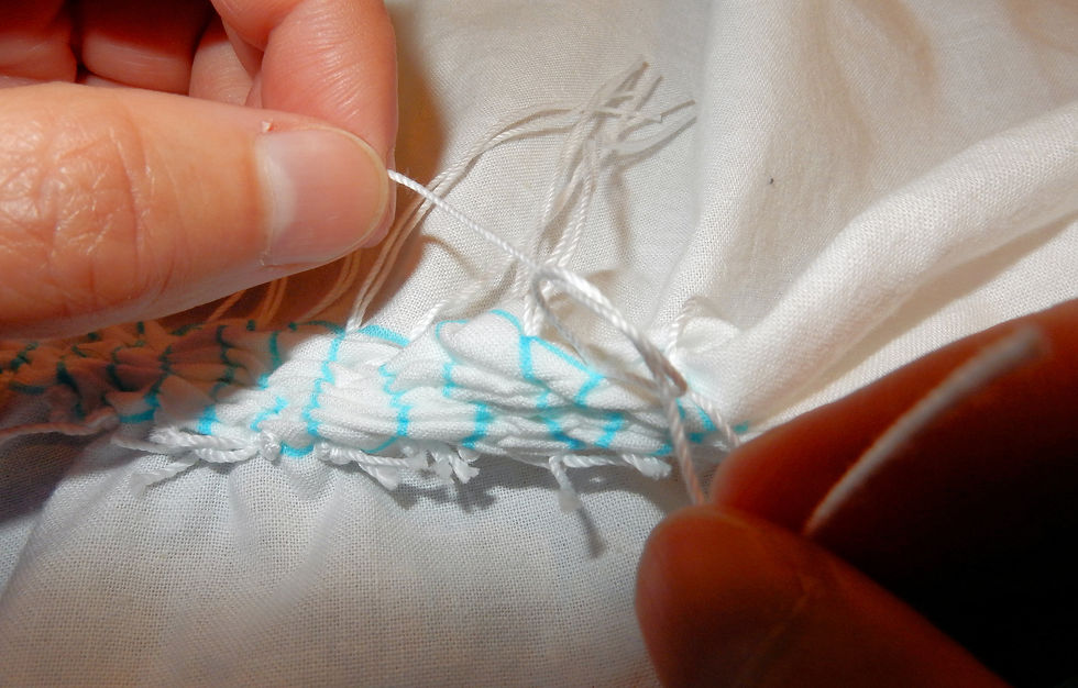 Tying thread back on itself.