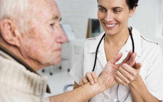 A nurse checking an elderly mans pulse