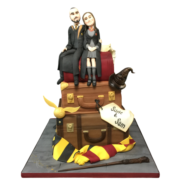 Magical wedding cake featuring sugar paste suitcases, characters, and vibrant accessories.