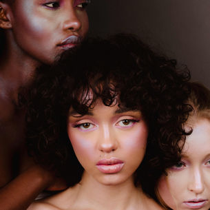 Editorial beauty makeup with soft pink tones, monochromatic glowing skin on diverse models. 