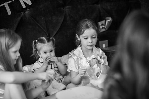 Children sharing a quiet moment during wedding preparations