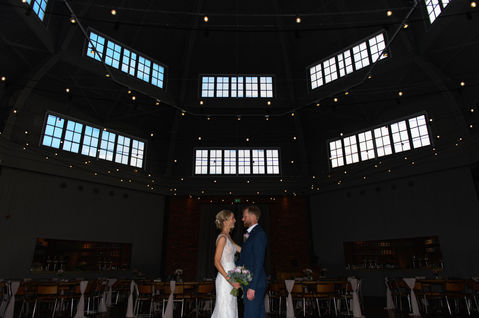 A portrait beneath the brewery ceiling lights — OL and JULIE wedding