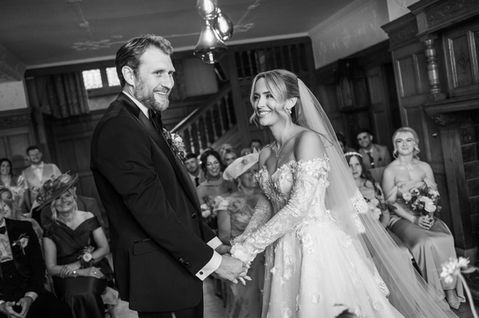 Michael and Danielle holding hands during their wedding vows