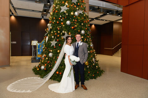Gregg and Lesley Ann beside a decorated Christmas tree