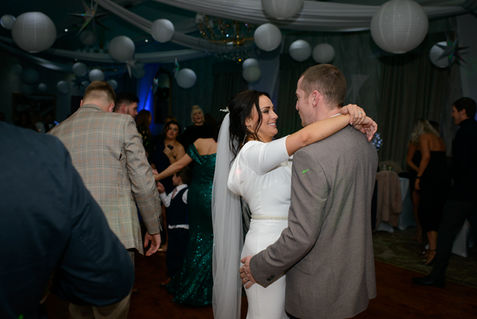 Guests celebrating with the newlyweds on the dance floor