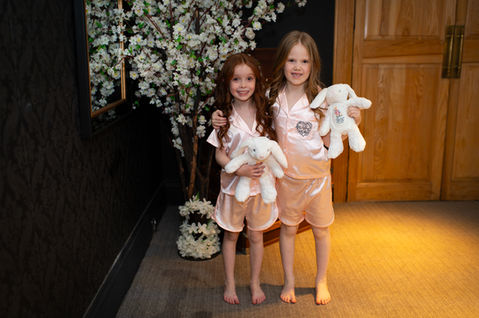 Flower girls standing together with their wedding bouquets