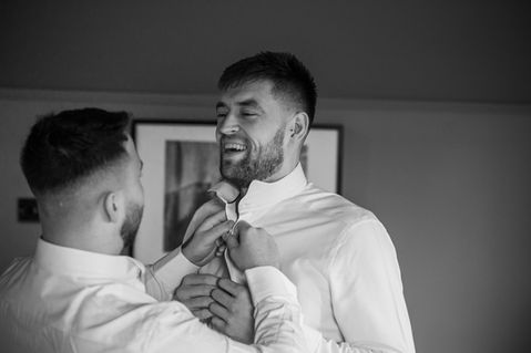 The groom having his tie adjusted — JAMES and KIRSTEN wedding