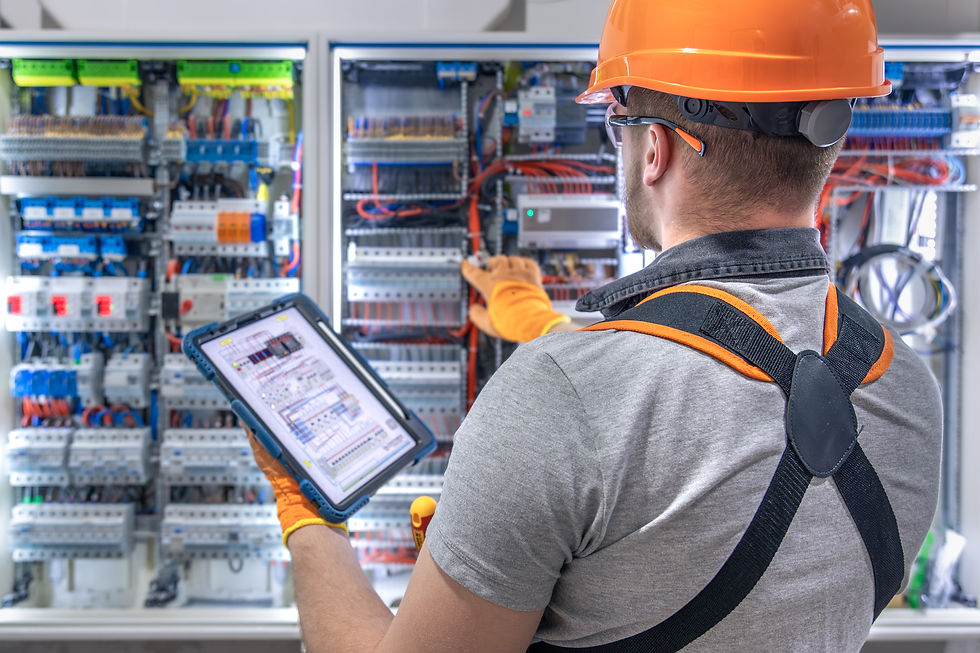male-electrician-overalls-focused-work-switchboard-with-fuses-using-tablet (1).jpg