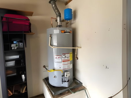 Gas water heater installed in a Texas garage with expansion tank and vent pipe, typical North Texas residential setup