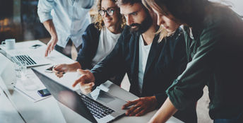 colleagues looking at laptop screen