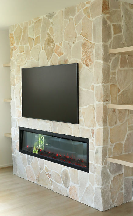 Wall-mounted TV on a natural stone fireplace feature wall, Gold Coast