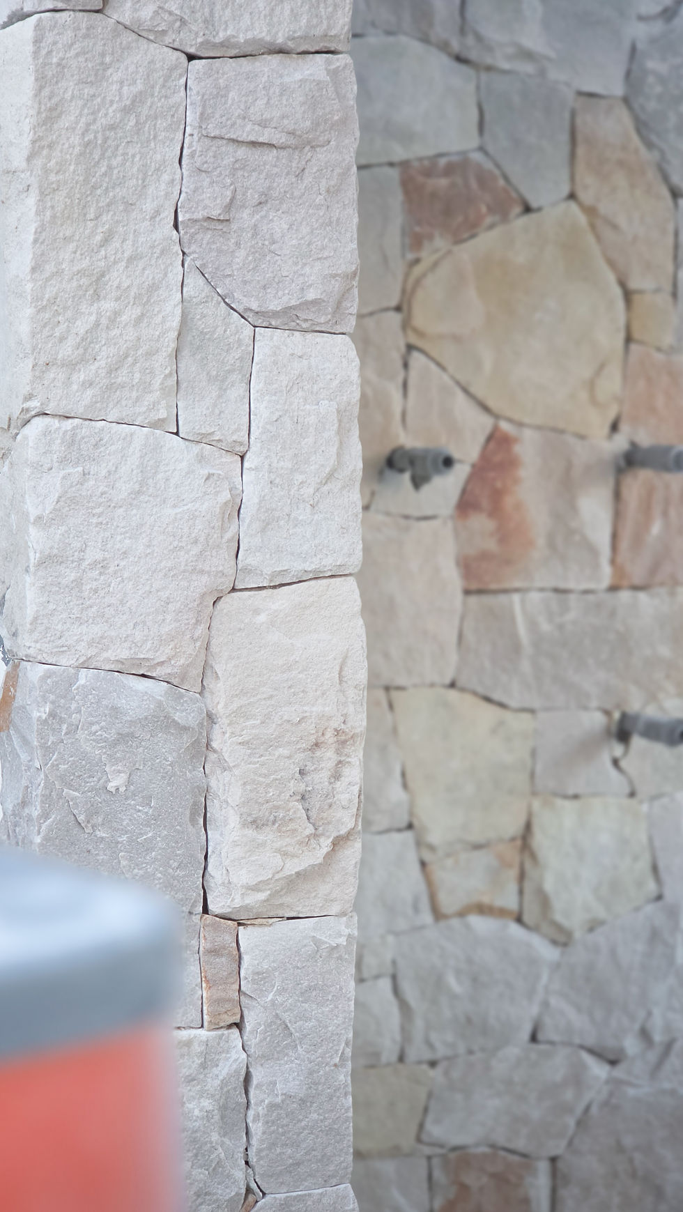 Natural stone feature wall with varied rectangular stone blocks, Casuarina property