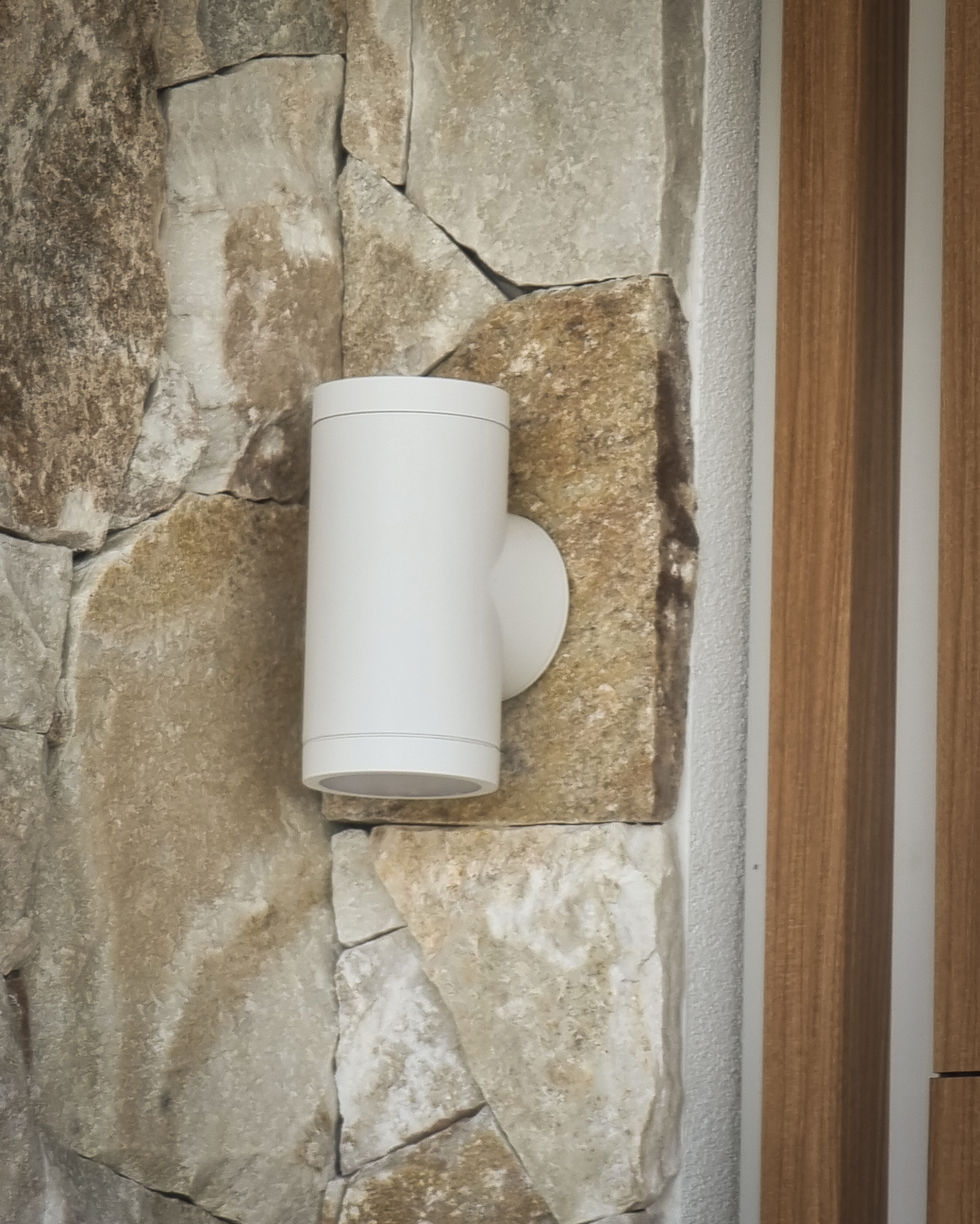 Outdoor wall light fixture set into dry-stack stone cladding, Casuarina duplex