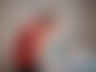 A woman with her head in her hands looking at a computer