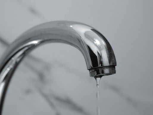 Close-Up of Water Faucet Dripping in Bathroom