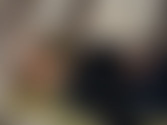 A Woman Meditating while Lying Down with a person's hands positioned above the forhead and stomach