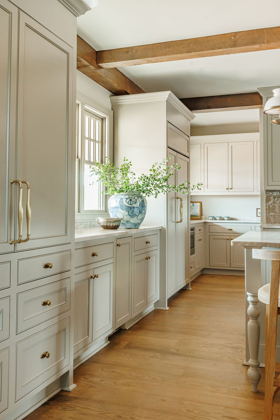 Elegant kitchen with white cabinets and wooden accents.