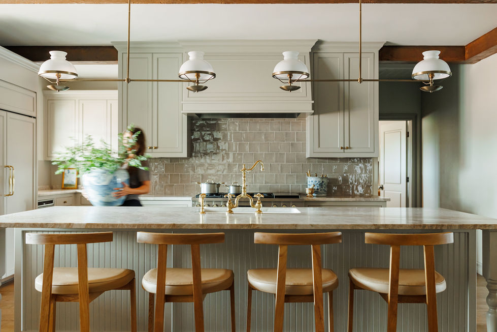 Modern kitchen with island and pendant lights.