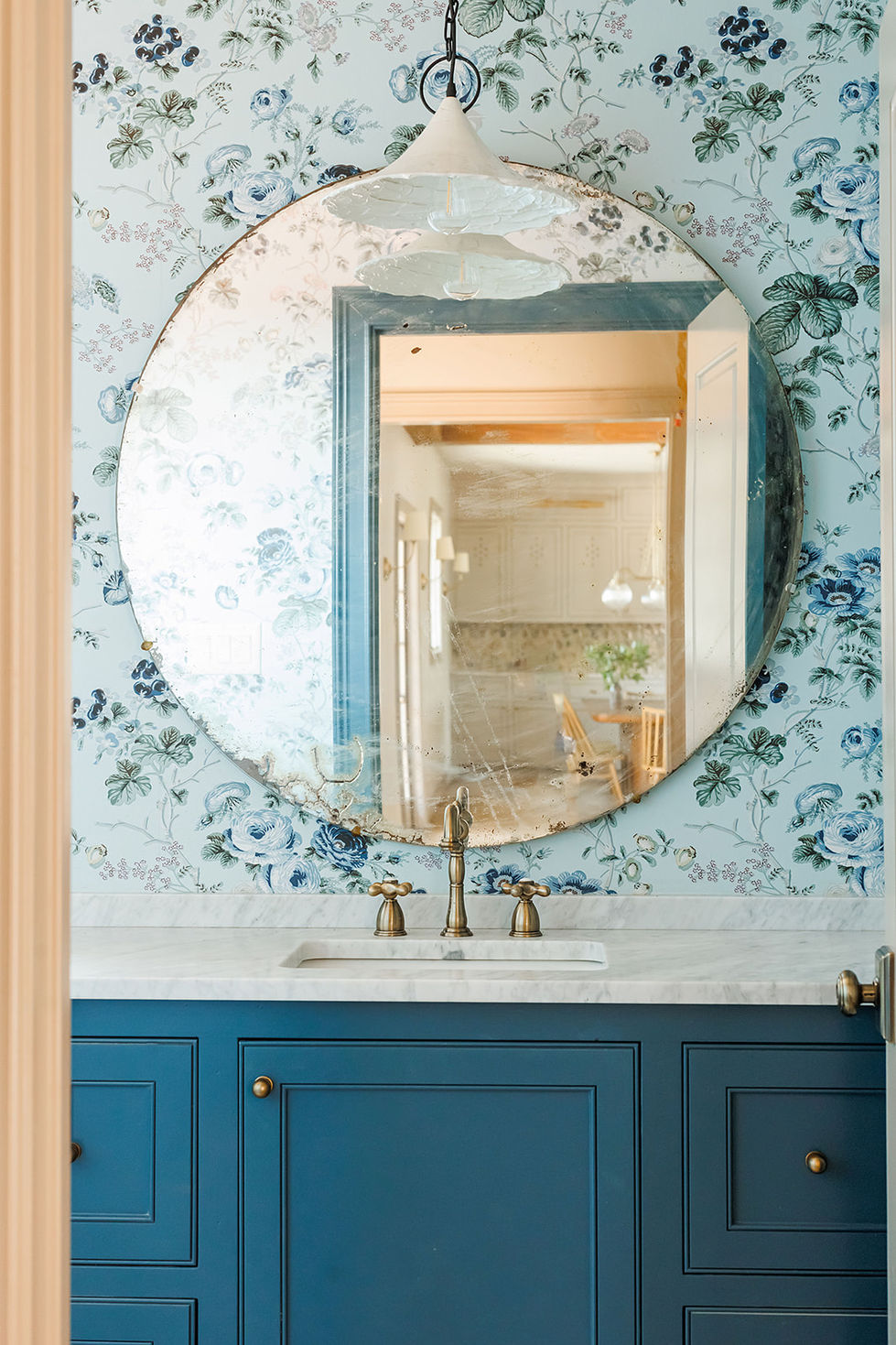 Round mirror reflecting elegant interior design elements.