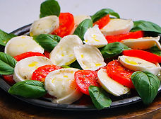 Caprese salad with fresh mozzarella, tomatoes, basil, and olive oil