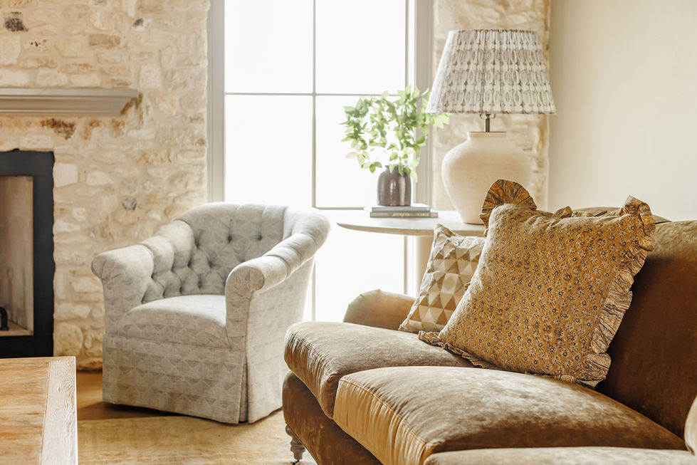 Cozy living room with plush furniture and soft lighting.