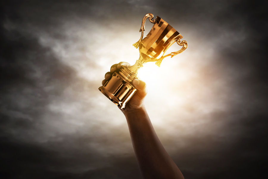 A hand with winning trophy