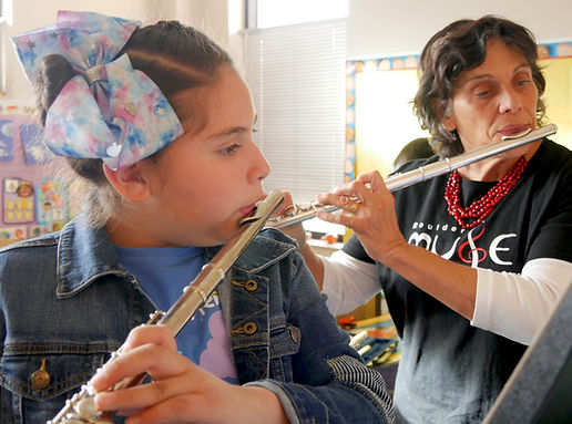 Instructor and student playing flutes