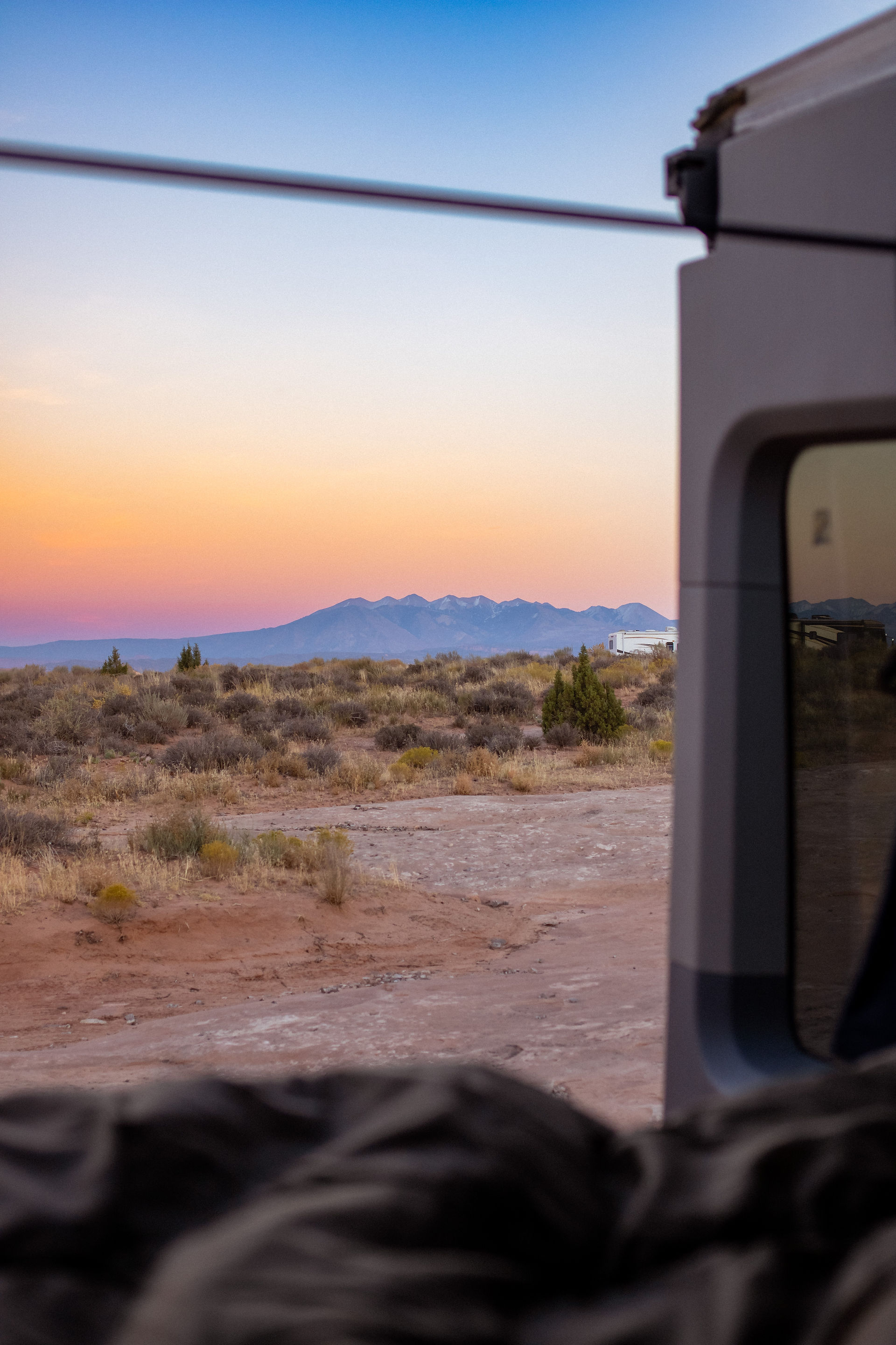 View from a van of mountains with the sunset