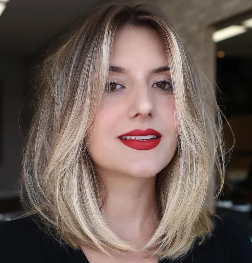 girl with mid length haircut with face framing layers 